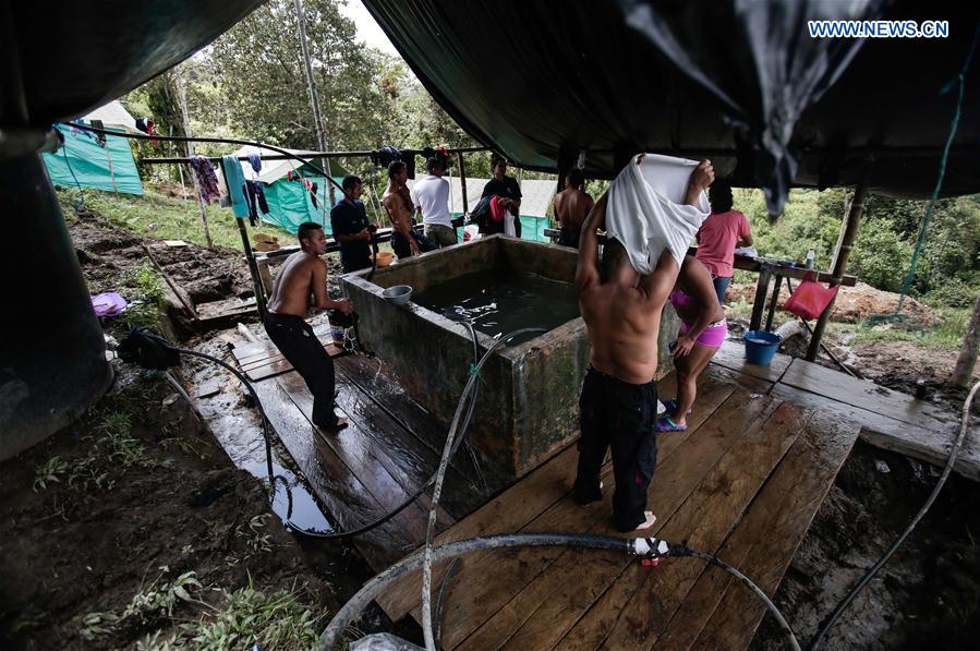 Members of the Armed Revolutionary Forces of Colombia (FARC) shower in a camp in Caldonoin Icononzo, Tolima department, Colombia, on March 1, 2017.