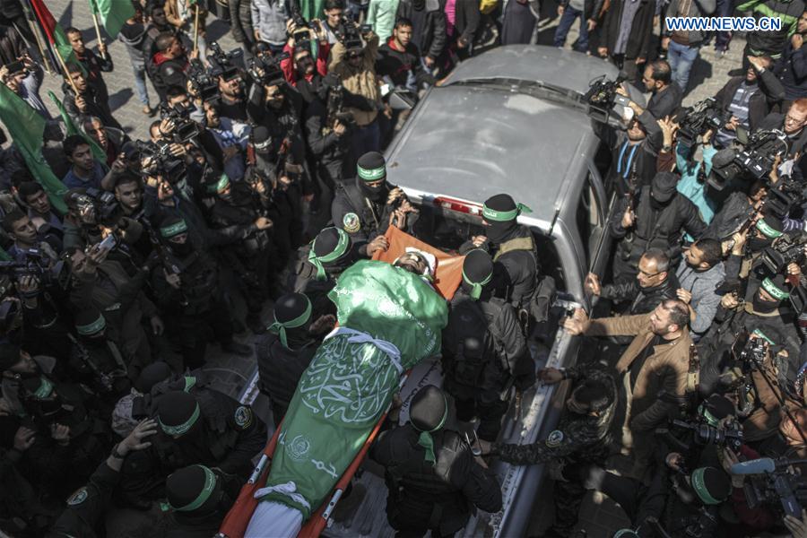 People surround the body of Mazen Fuqaha'a, one of the top and prominent Hamas militants, during his funeral in Gaza City, March 25, 2017. 