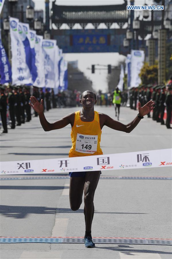 Titus Tuwei from Kenya sprints to the finish line during the Zhengkai International Marathon in Kaifeng, city of central China's Henan Province on March 26, 2017. 
