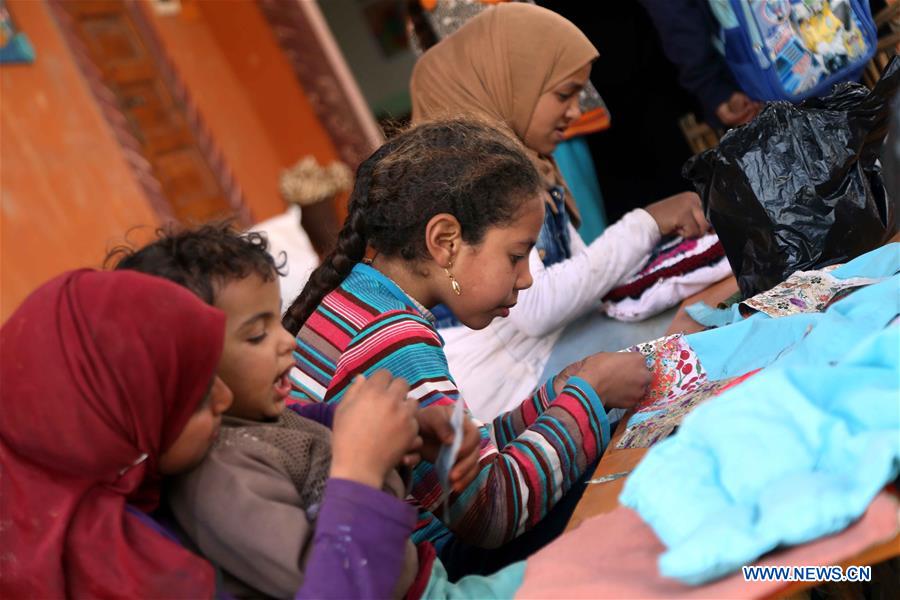 Children have a knitting class at lady Didi's Nile River School in Ayyat district on the outskirts of Giza Province, about 100 km south of Cairo, capital of Egypt, on March 26, 2017. Diana Sandor, known as Didi, an old Hungarian-born German-raised woman, covered the long distance from West to East six years ago to open her Nile River School as a charitable kindergarten and educational center at the heart of remote, impoverished Baharwa village of Ayyat district on the outskirts of Giza Province, about 100 km south of the Egyptian capital Cairo. Didi said she started building the center 'brick by brick,' through little donations from friends and volunteers around the world and that she is concerned with 'teaching children life,' not just languages and skills. (Xinhua/Ahmed Gomaa) 