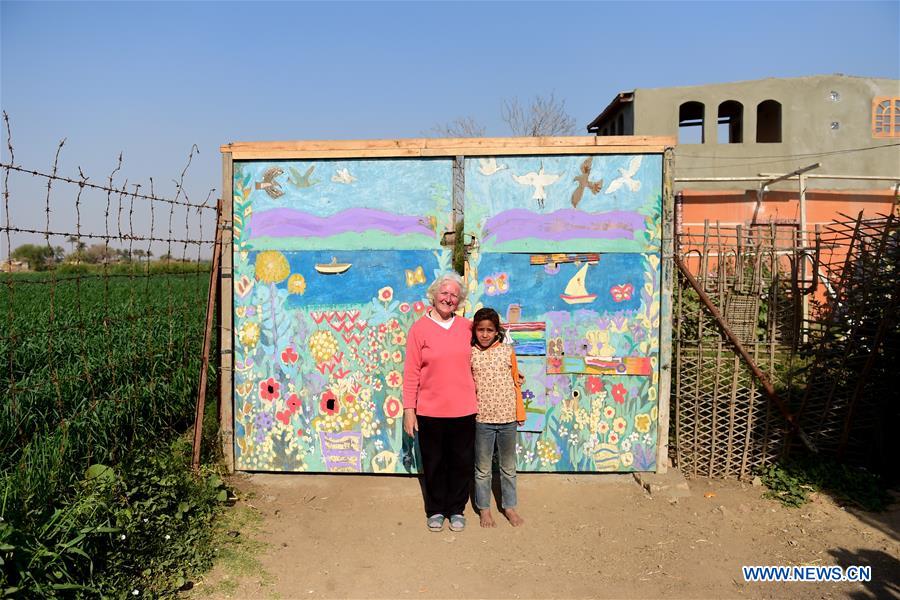 Lady Didi (L) poses for photo with an Egyptian girl at the gate of her Nile River School in Ayyat district on the outskirts of Giza Province, about 100 km south of Cairo, capital of Egypt, on March 26, 2017. Diana Sandor, known as Didi, an old Hungarian-born German-raised woman, covered the long distance from West to East six years ago to open her Nile River School as a charitable kindergarten and educational center at the heart of remote, impoverished Baharwa village of Ayyat district on the outskirts of Giza Province, about 100 km south of the Egyptian capital Cairo. Didi said she started building the center 'brick by brick,' through little donations from friends and volunteers around the world and that she is concerned with 'teaching children life,' not just languages and skills. (Xinhua/Zhao Dingzhe) 