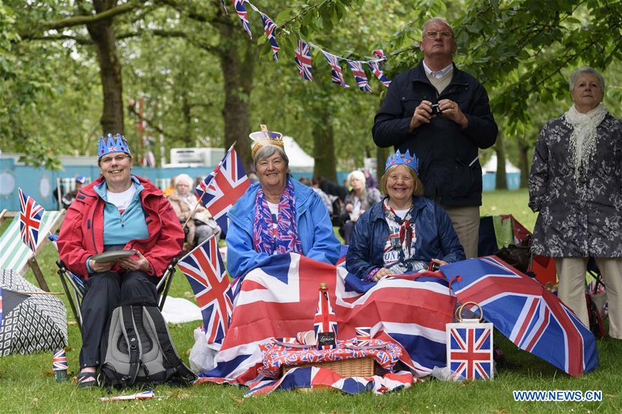 People celebrate Queen Elizabeth II's official 90th birthday at Trafalgar Square in London, June 12, 2016.