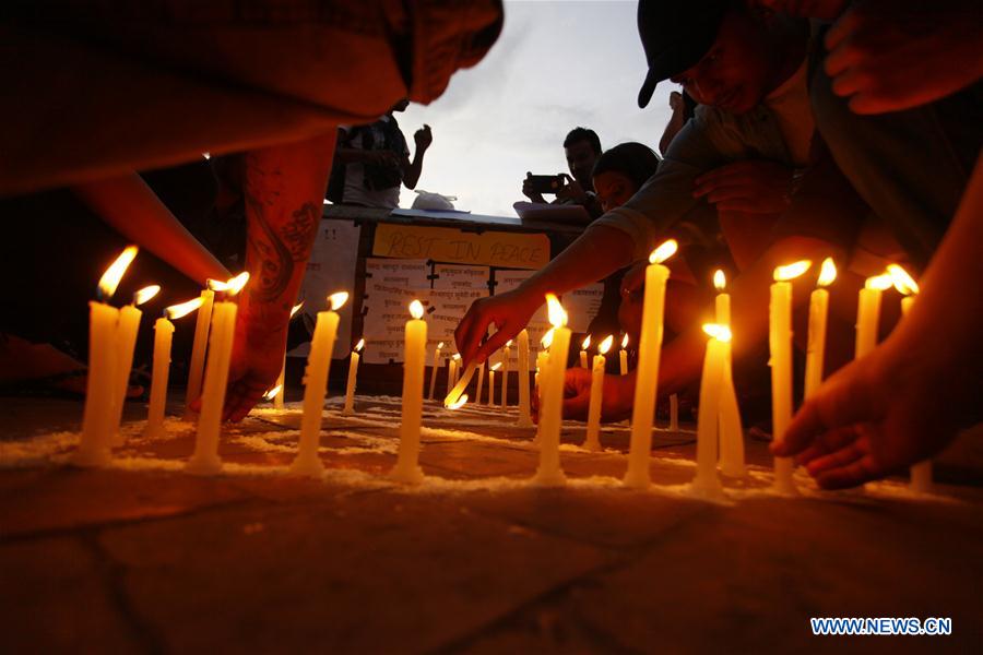 Nepalese people hold candles to memorize victims of a suicide bombing in Afghanistan, in Kathmandu, Nepal, June 23, 2016.