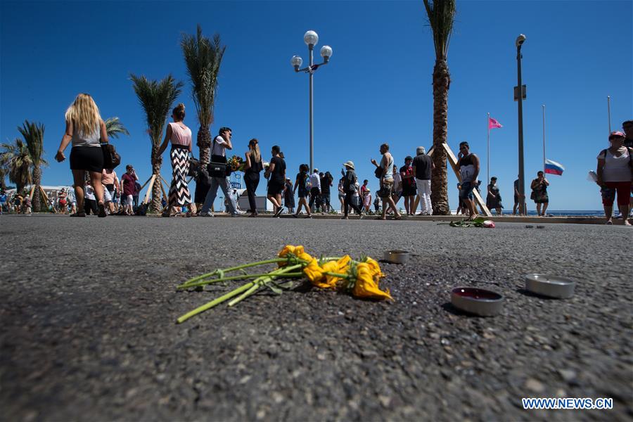 People gather to mourn the victims on the attack scene at the Promenade des Anglais in Nice, France, July 16, 2016.