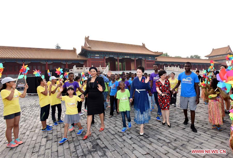 Chinese President Xi Jinping's wife Peng Liyuan, who is also the World Health Organization goodwill ambassador for tuberculosis and HIV/AIDS, attends the opening ceremony for 'Love in the Sunshine'-- the 2016 China-Africa Children Summer Camp, at the Palace Museum in Beijing, capital of China, July 29, 2016. 