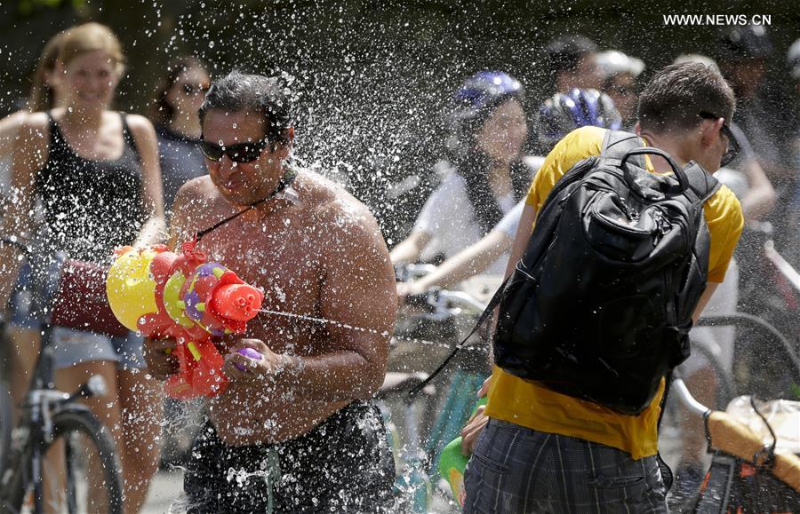 People with water guns participate in Vancouver Water Fight event at Stanley Park in Vancouver, Canada, on Aug. 6, 2016.