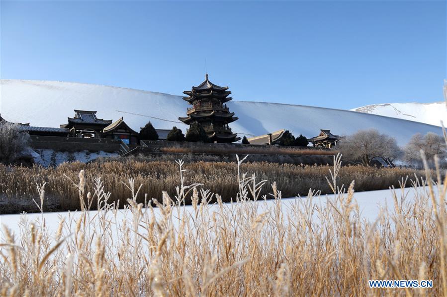 Photo taken on Jan. 11, 2017 shows the panorama of snow scenery of the Crescent Spring and Singing Sand Dune scenic site of Dunhuang, northwest China's Gansu Province. A recent snow made the scenic site decorated with pure white. (Xinhua/Zhang Xiaoliang) 