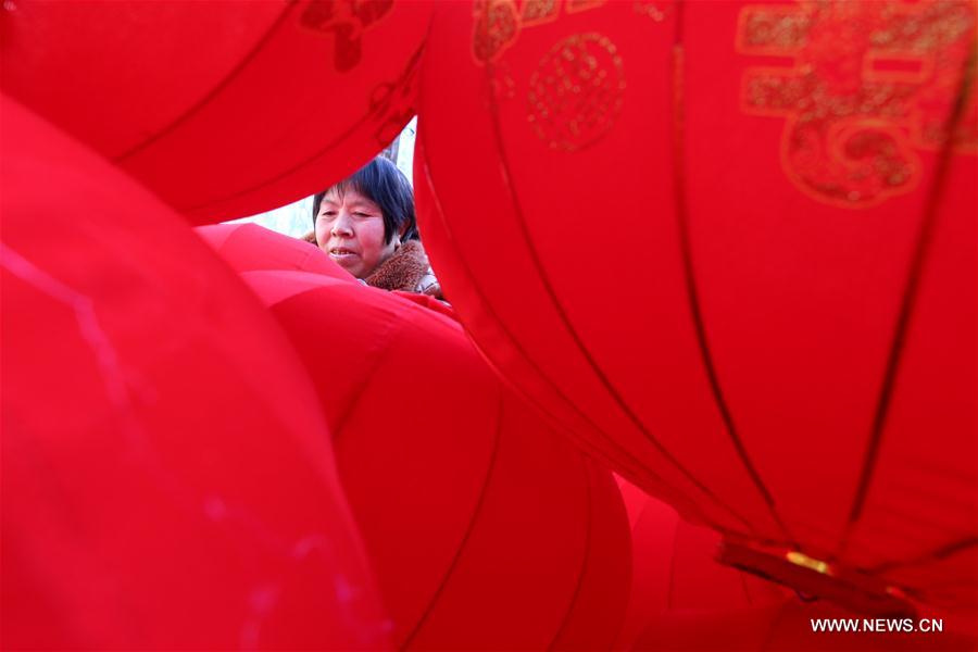 A villager makes red lanterns in Beileng Township of Wenxian County, central China's Henan Province, Jan. 12, 2017. Villagers need to keep up with the lantern orders to meet the Spring Festival market demand. The Spring Festival falls on Jan. 28 this year. (Xinhua/Xu Hongxing) 