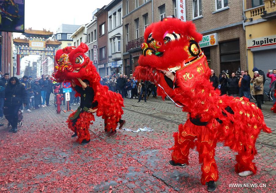 People watch lion dance to celebrate the Chinese Lunar New Year at Chinatown in Antwerp, Belgium, on Feb. 1, 2017.
