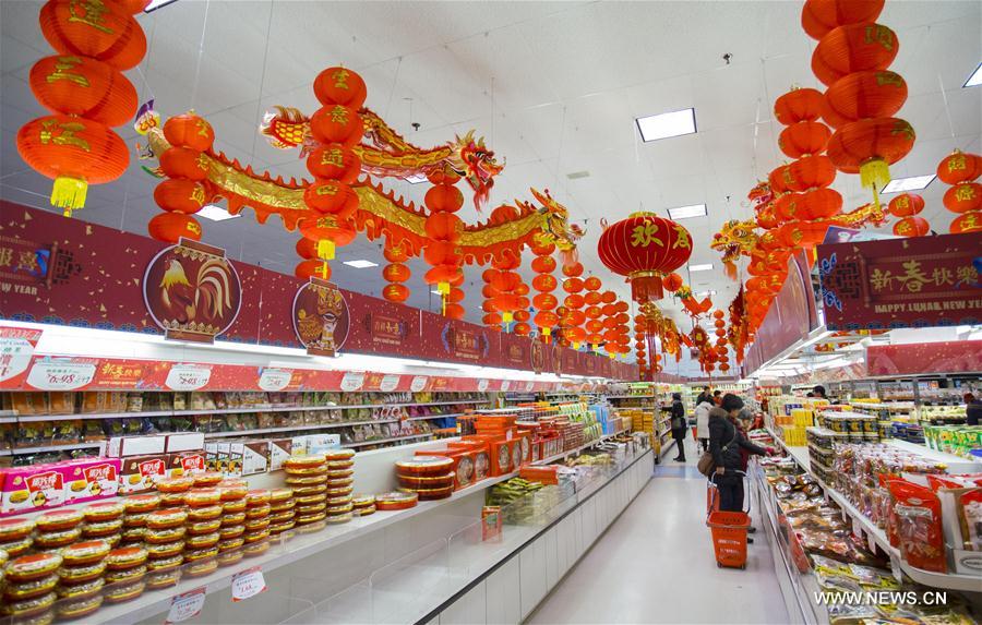 People shop at a Chinese supermarket with decorations celebrating the Chinese Lunar New Year in Toronto, Canada, Feb. 2, 2017.