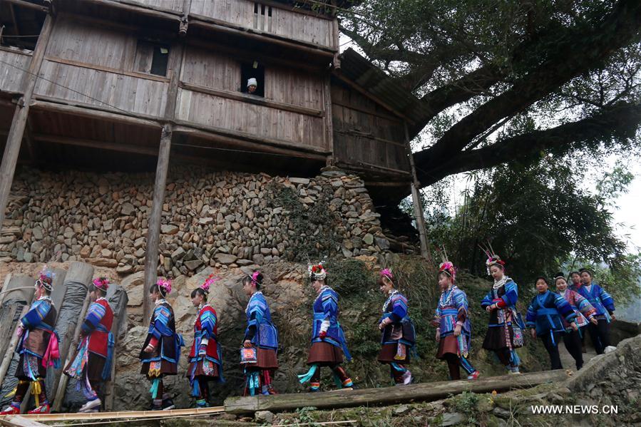 People of Miao ethnic group take part in 'Ganpingzi,' a 200-year-old folk event held on the 7th day of a lunar new year's first month, to pray for a good fortune in Gaoqing Miao Village of Diping Township of Liping County, southwest China's Guizhou Province, Feb. 3, 2017.