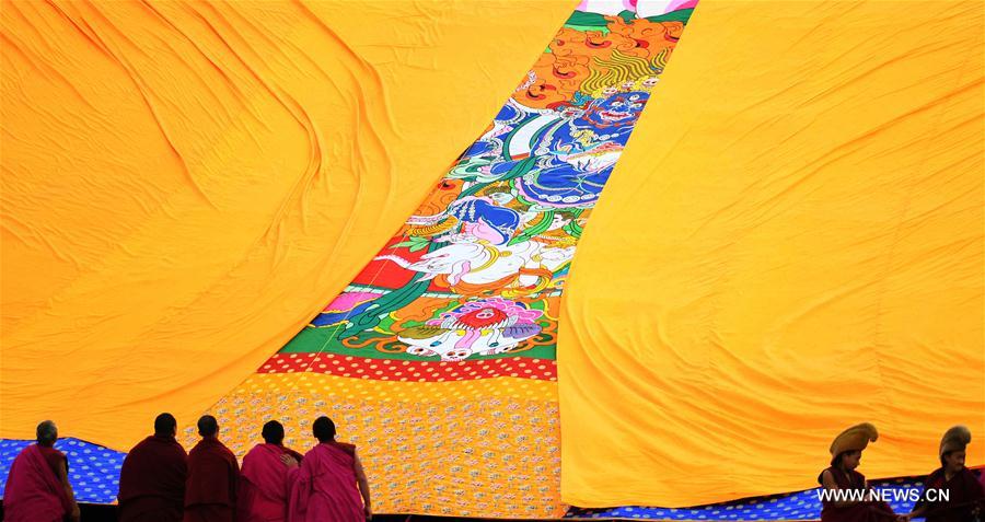 The annual display of Buddha thangka, a Tibetan Buddhist scroll painting, in Labrang Monastery is a Tibetan Buddhism traditional praying for a good year.