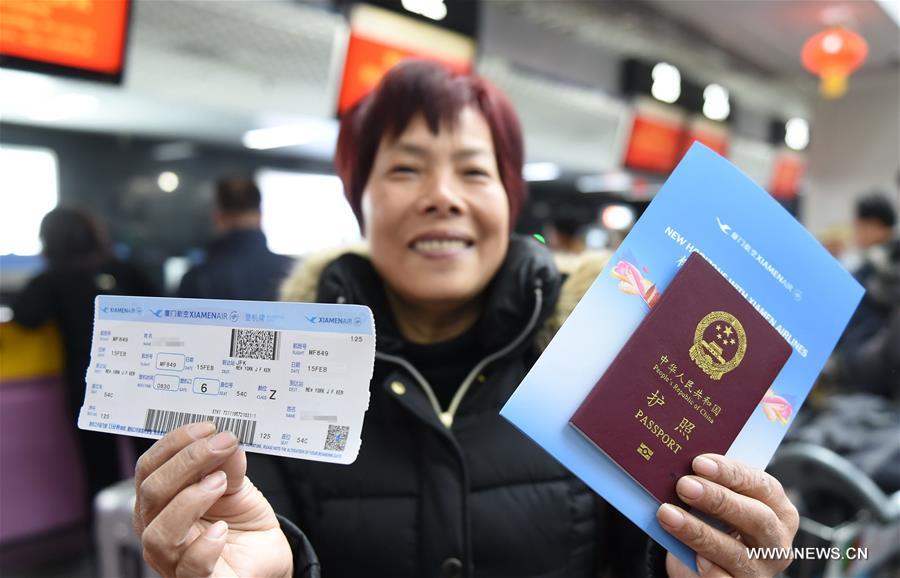 A passenger of MF849 shows her ticket at the Fuzhou International Airport in Fuzhou, capital of southeast China's Fujian Province, Feb. 15, 2017. MF849, the first direct flight of Xiamen Airlines from Fuzhou to New York, took off here on Wednesday. (Xinhua/Lin Shanchuan)