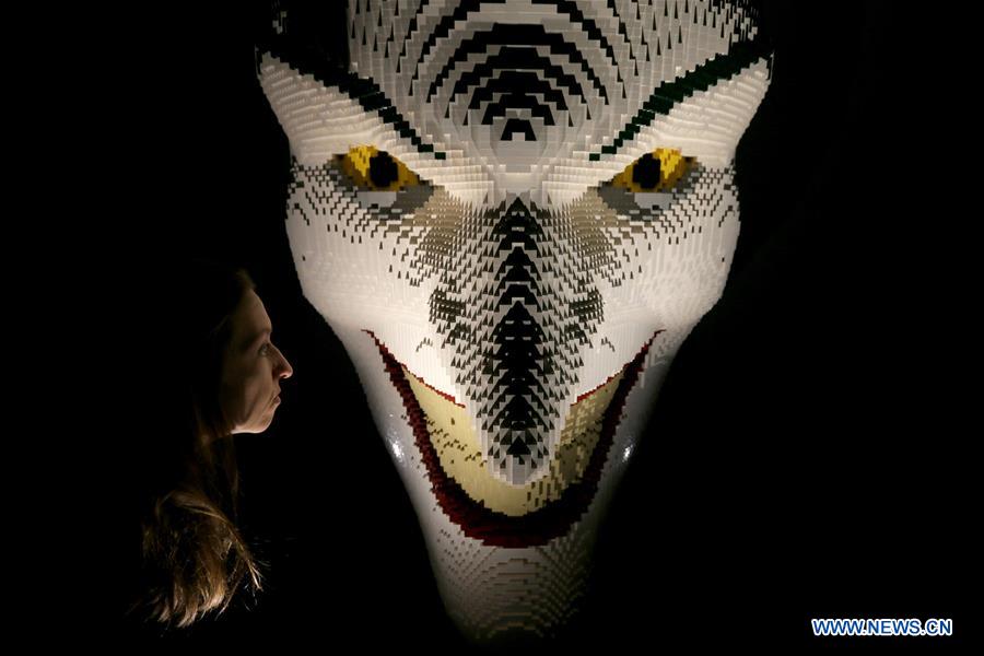 A visitor looks at the work 'The Joker Facemask' made of Lego bricks during the exhibition 'The Art of Brick: DC Super Heroes' by artist Nathan Sawaya, on the South Bank in London, Britain, on Feb. 28, 2017. The exhibition featured sculptures based on the DC Comics universe and used more than 2 million Lego bricks. 