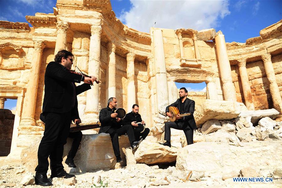 A musical band plays amid the rubble of the ruined Roman Theater in the ancient city of Palmyra, central Syria, on March 4, 2017. The Syrian army announced in a statement that the Syrian forces captured the ancient city of Palmyra in central Syria on Thursday after battles with the Islamic State (IS) group. 