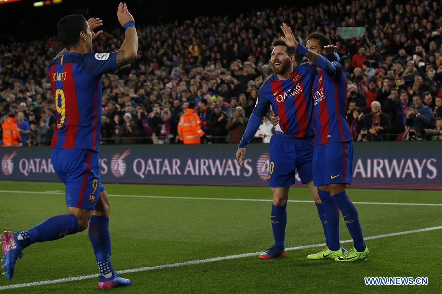 Barcelona's Lionel Messi (C) celebrates with Neymar (R) and Luis Suarez after scoring during the Spanish first division soccer match between FC Barcelona and Celta de Vigo at the Camp Nou Stadium in Barcelona, Spain, March 4, 2017. Barcelona won 5-0.
