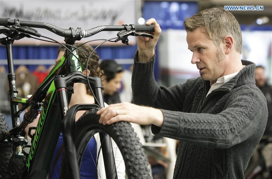 A resident takes a closer look at an electric mountain bicycle displayed at the Vancouver Bike Show in Vancouver, Canada, March 4, 2017. 