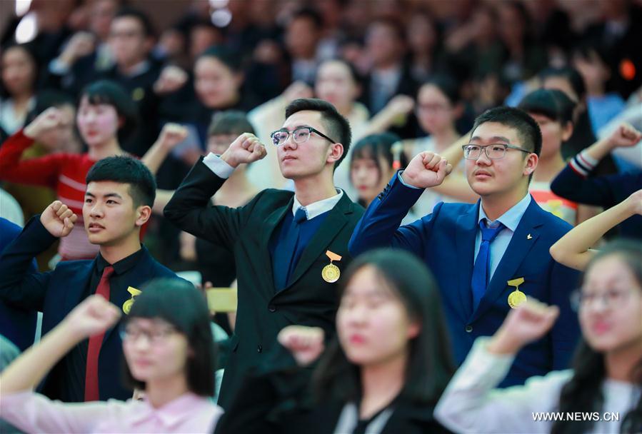 Students cheer at the adult ceremony for 18-year-old senior students in high school in Hohhot, capital of north China's Inner Mongolia Autonomous Region, March 7, 2017
