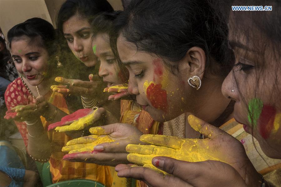 Indian girls blow colored powder during an event to celebrate the Holi, the festival of colors, at Rabindra Bharati University in Kolkata, India, March 7, 2017.