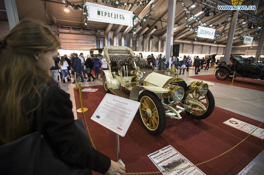 A visitor reads about information of a Mercedes Simplex 28/32PS on display at an old timer exposition in Moscow, Russia, on March 8, 2017. 