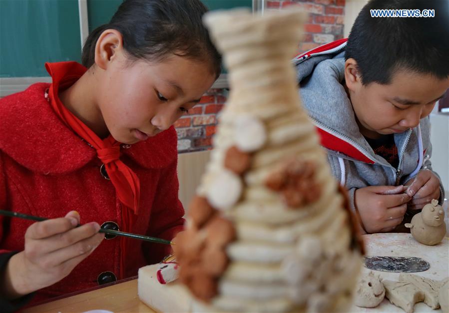 Pupils make pottery wares during a class at a primary school in Zhangjiakou City, north China's Hebei Province, March 13, 2017. 