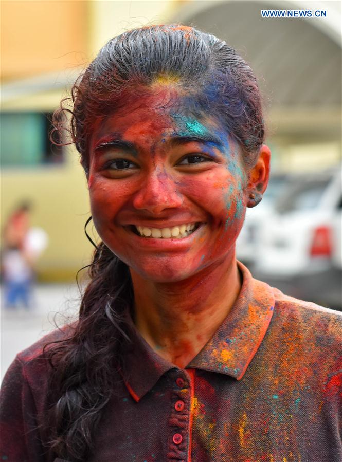 A girl of Indian community in Qatar is covered in colored powder during celebrations of the Holi, the Indian festival of Colors, in Doha, capital of Qatar, on March 13, 2017. 