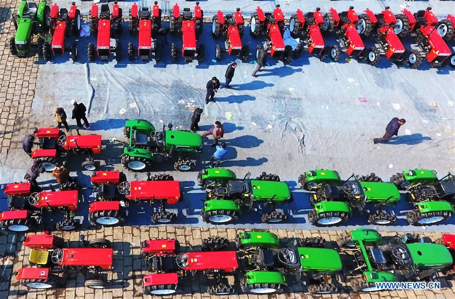 Farmers view agricultural machinery at a market in Harbin, northeast China's Heilongjiang Province, March 16, 2017. Farmers in Heilongjiang began to choose agricultural machinery on the market for the upcoming spring ploughing.(Xinhua/Wang Jianwei) 