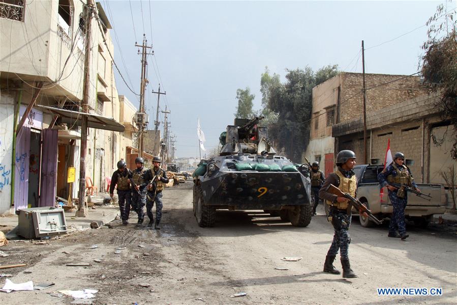 Iraqi federal police forces patrol the street in Alkulat area, western Mosul, Iraq, on March 20, 2017. As Iraqi forces gained more territories in western Mosul, the federal police strengthened their control on the newly-liberated areas and began clearing the improvised explosive devices left by Islamic State group. (Xinhua/Yaser Jawad) 