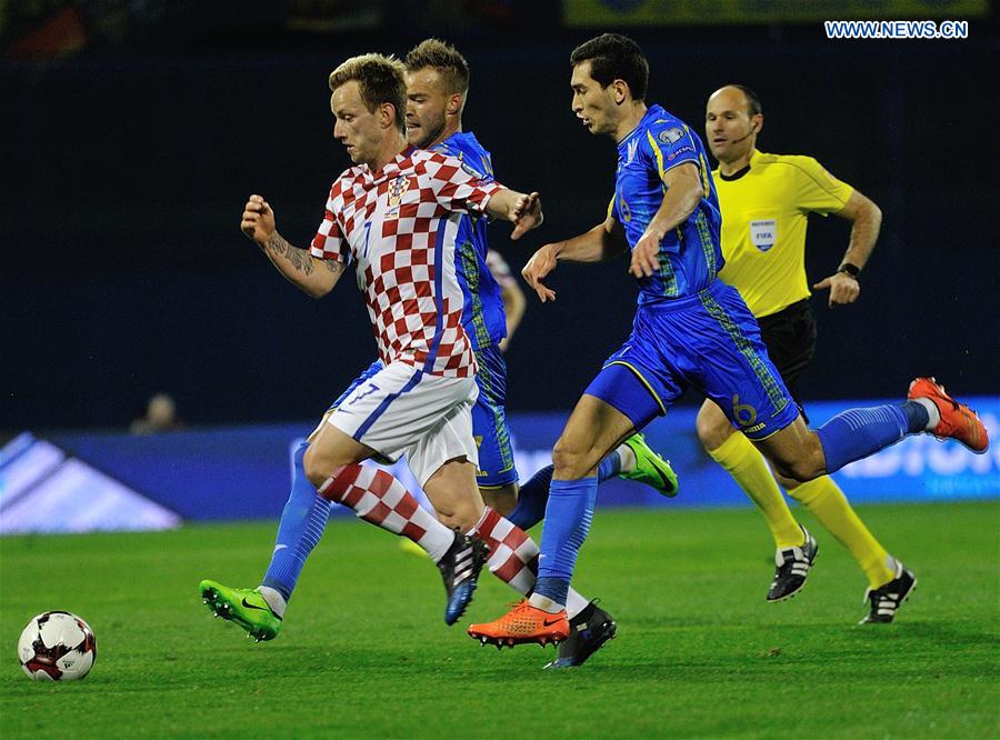 Ivan Rakitic (L) of Croatia breaks through during the FIFA World Cup 2018 qualifier match against Ukraine at the Maksimir stadium in Zagreb, capital of Croatia, March 24, 2017.