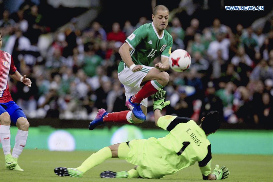 Mexico's Javier Hernandez (top) vies with Costa Rica's goalkeeper Keylor Navas during the qualifying match for 2018 Russia World Cup against Costa Rica in Mexico City, capital of Mexico, March 24, 2017. 