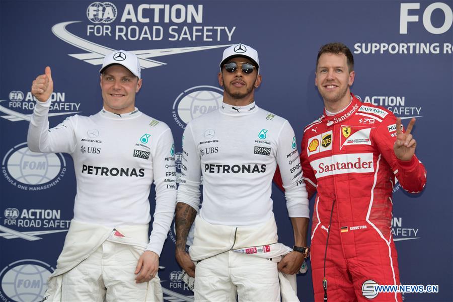 Mercedes AMG Petronas Formula One driver Lewis Hamilton (C) of Britain, teammate Valtteri Bottas (L) of Finland and Scuderia Ferrari Formula One driver Sebastian Vettel of Germany pose for photo after the qualifying session of the Australian Formula One Grand Prix at Albert Park circuit in Melbourne, Australia on March 25, 2017. Lewis Hamilton will start from the pole position. The Australian Formula One Grand Prix will take place in Melbourne on March 26. (Xinhua/Bai Xue) 