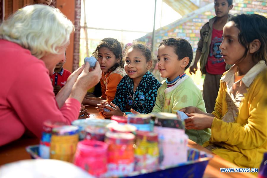 Lady Didi (L) teaches children how to shape clay at her Nile River School in Ayyat district on the outskirts of Giza Province, about 100 km south of Cairo, capital of Egypt, on March 26, 2017. Diana Sandor, known as Didi, an old Hungarian-born German-raised woman, covered the long distance from West to East six years ago to open her Nile River School as a charitable kindergarten and educational center at the heart of remote, impoverished Baharwa village of Ayyat district on the outskirts of Giza Province, about 100 km south of the Egyptian capital Cairo. Didi said she started building the center 'brick by brick,' through little donations from friends and volunteers around the world and that she is concerned with 'teaching children life,' not just languages and skills. (Xinhua/Zhao Dingzhe) 