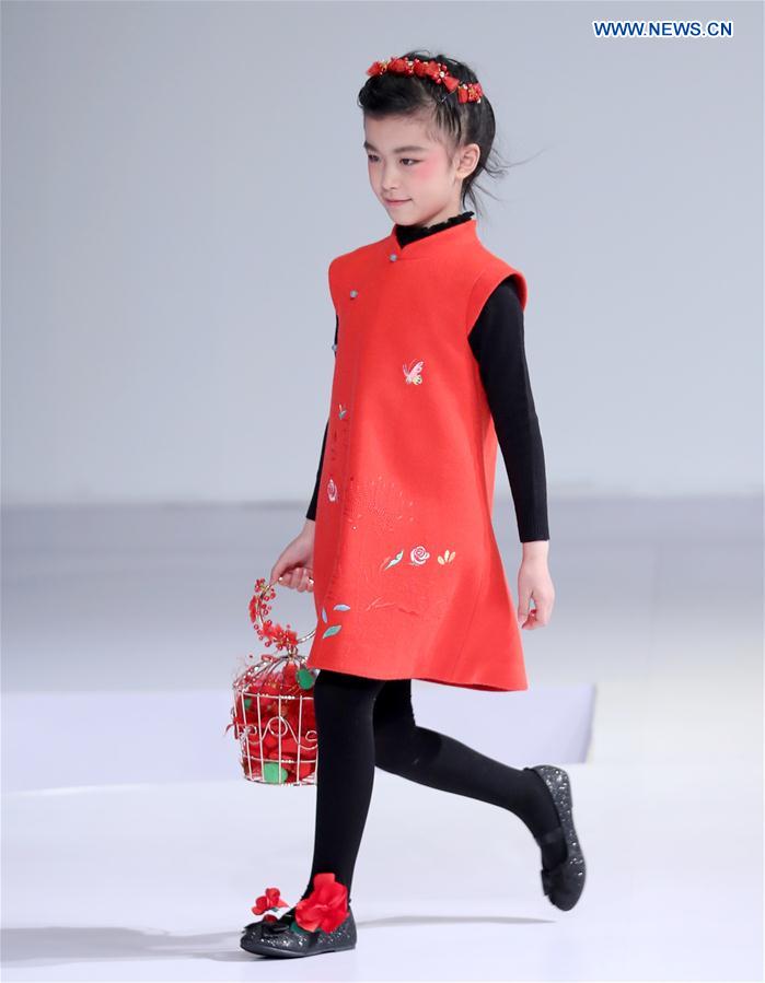 A young model walks the runway at the Wangxiaohe children's collection show by Fan Yong during China Fashion Week in Beijing, capital of China, March 26, 2017.