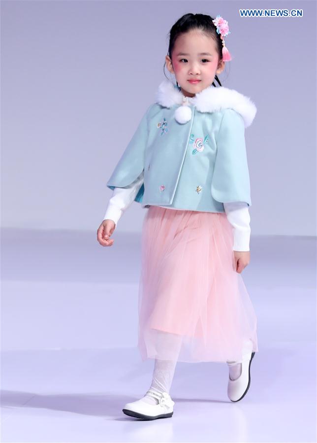 A young model walks the runway at the Wangxiaohe children's collection show by Fan Yong during China Fashion Week in Beijing, capital of China, March 26, 2017. 