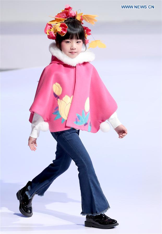 A young model walks the runway at the Wangxiaohe children's collection show by Fan Yong during China Fashion Week in Beijing, capital of China, March 26, 2017.