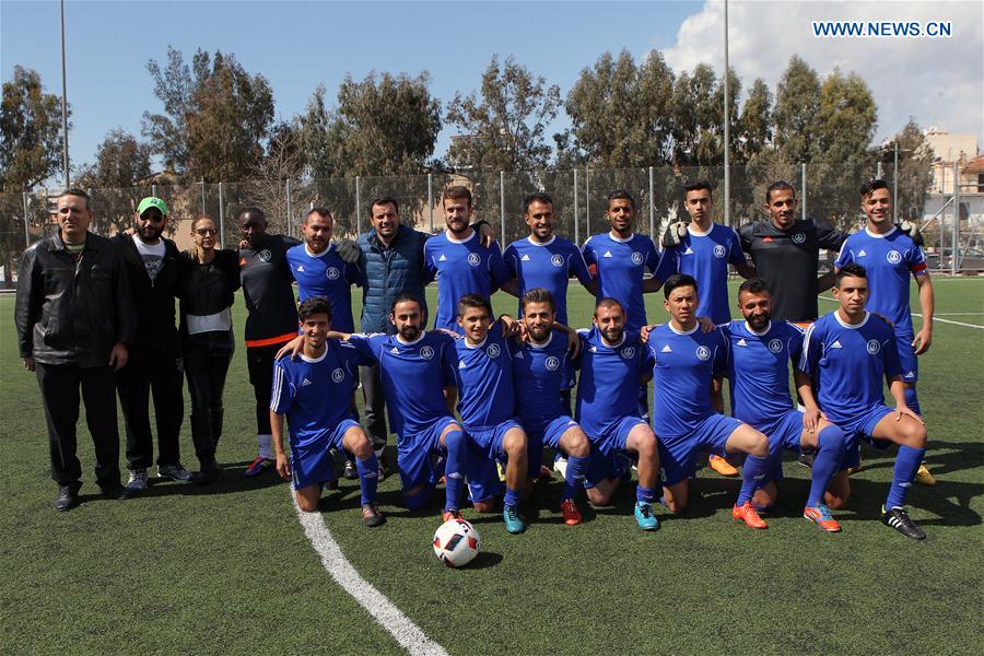 Refugee's Athletic Hope Football Club players pose for a photo during a friendly match in Piraeus, Greece, on March 13, 2017. 