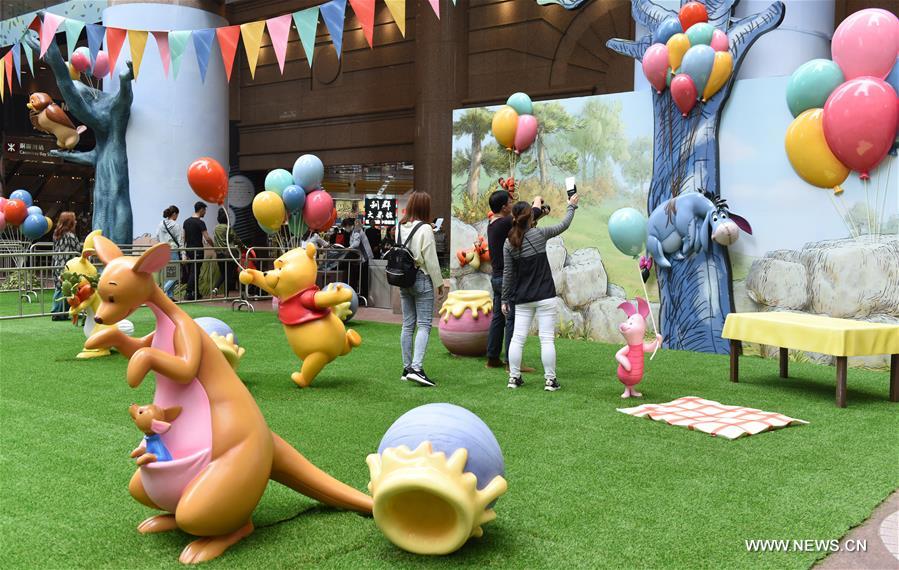 Tourists take photos during a Winnie the Pooh exhibition in Hong Kong, south China, March 29, 2017.