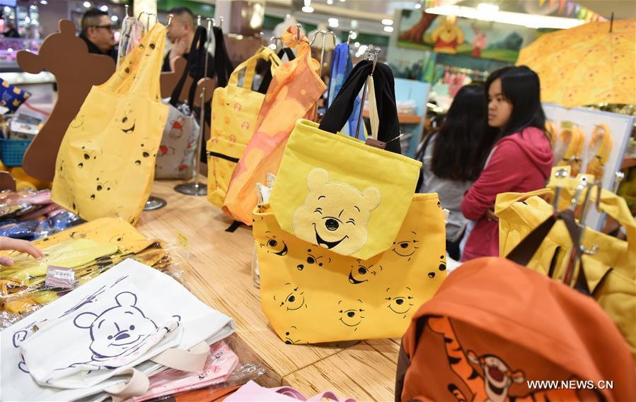 Tourists shop at a themed store during a Winnie the Pooh exhibition in Hong Kong, south China, March 29, 2017.