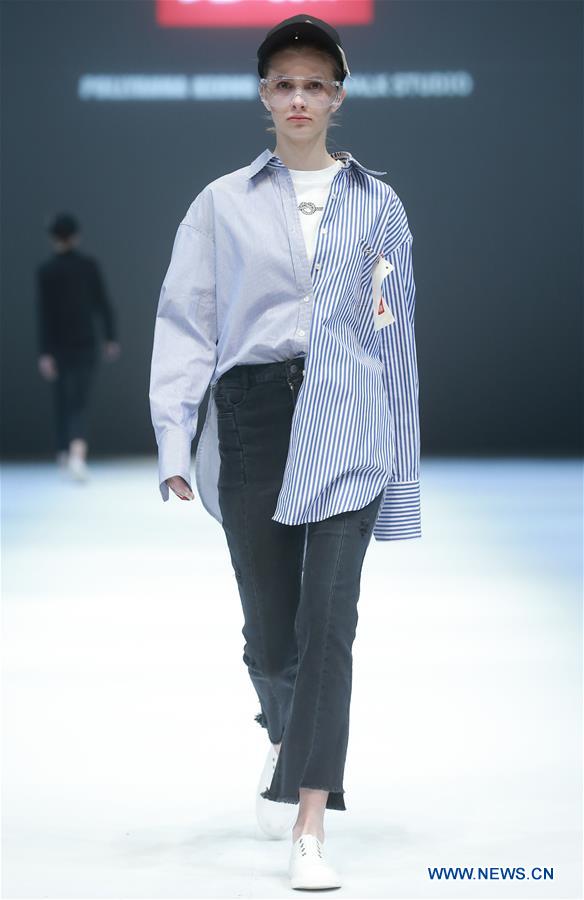 A model presents a creation designed by Jiang Yueyin during China Fashion Week in Beijing, capital of China, March 29, 2017. (Xinhua/Chen Jianli) 