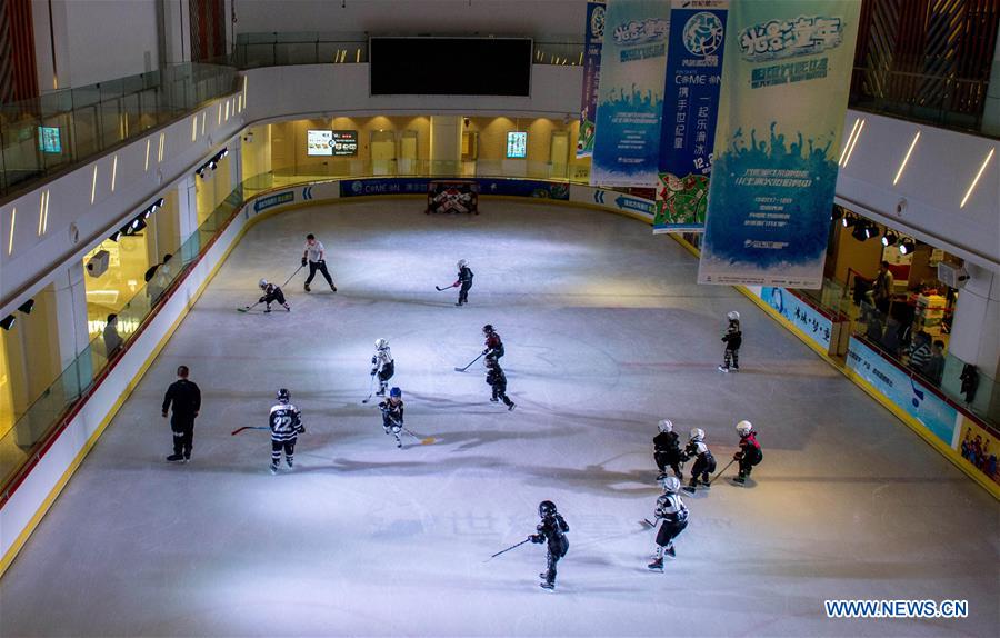 Boys play ice hockey in the Century Star Rink in Kunming, capital of southwest China's Yunnan province, March 18, 2017.