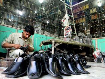 Workers make traditional shoes for upcoming Eid al-Fitr festival in NW Pakistan