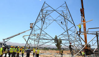Electricity workers fix high-voltage power lines in Damascus, Syria