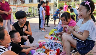 Children barter used toys and stationery at flea market in N. China