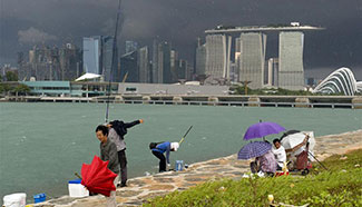 Anglers take shelter from rainstorm in Singapore