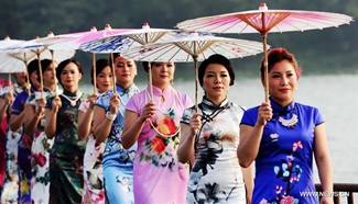 Ladies present Qipao in south China's Guangxi