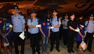 Chinese police bring 63 telecom fraud suspects back from Cambodia