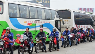 Migrant workers ride motrocycles home for Spring Festival in S China