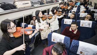 Students play violin on high-speed train