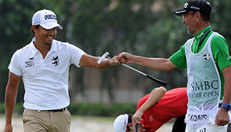 Golf players compete during Singapore Open