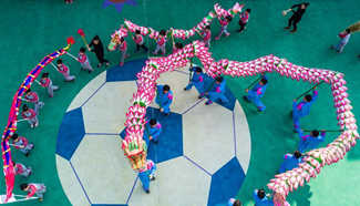 Children play traditional dragon dance in kindergarten